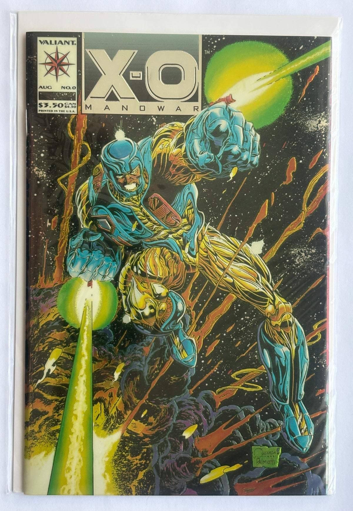 A comic book, X-O Manowar issue #2, featuring a dynamic illustration of a blue and gold armored superhero on a black space background with green energy effects. The comic is housed in a clear protective sleeve.