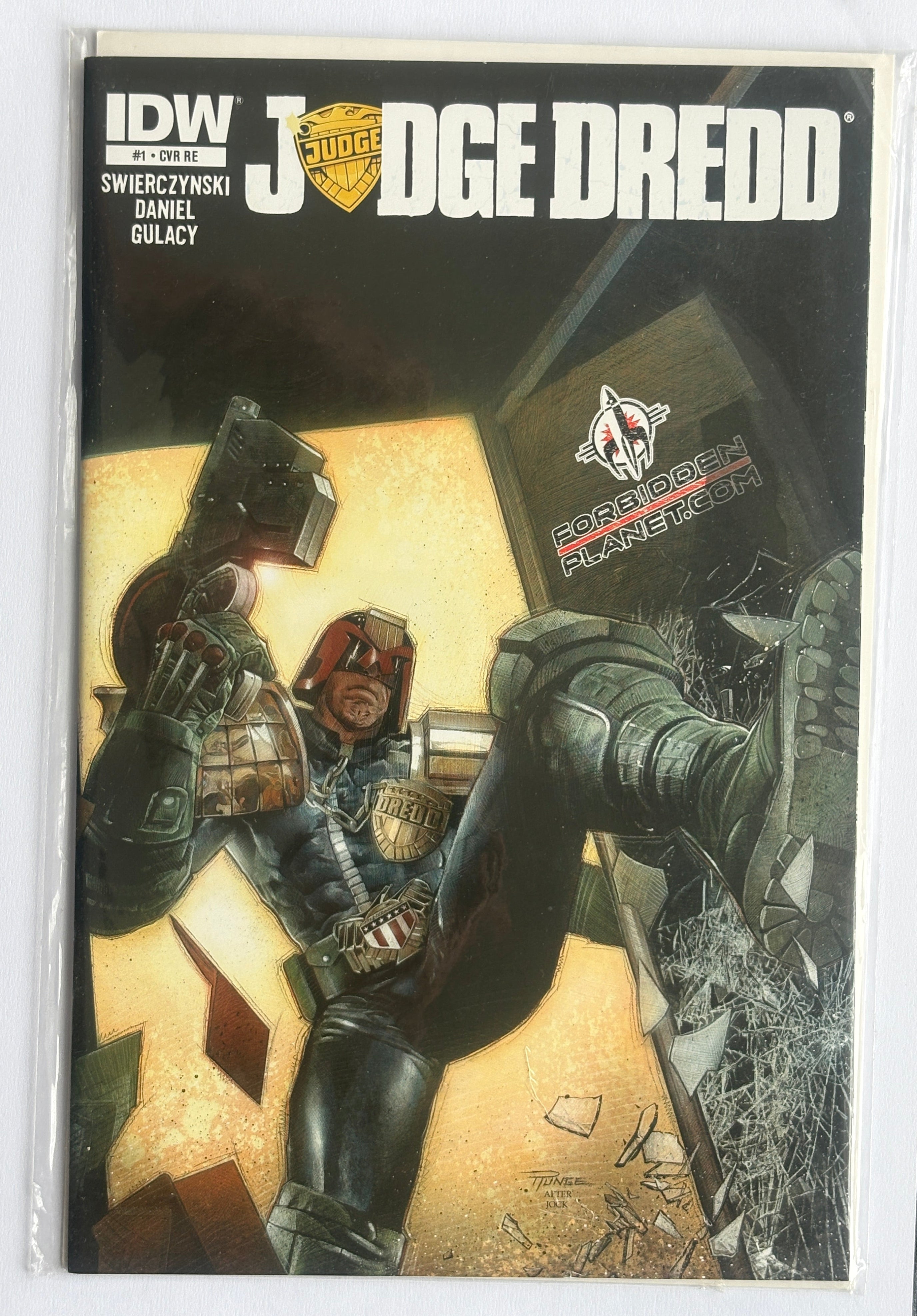 A comic book  titled 'Judge Dredd' with cover art showing a futuristic armored figure in a dramatic scene, photographed inside a clear protective sleeve on a white background.
