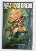 Judge Dredd comic book cover art inside a clear protective sleeve, featuring the character in green armor and helmet against a dark industrial background with a 'Law Breakers' sign.