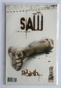 A comic book or magazine cover titled "SAW" with the subtitle "Rebirth" and an illustration of a severed foot, shown inside a clear protective sleeve against a dark background.